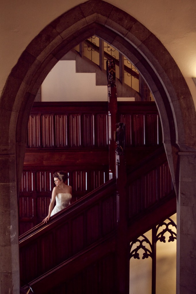 Autumnal Wedding arch in the manor house with bride walking down stairs