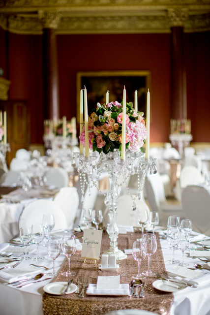 Pink, cream floral display on crystal candleabras