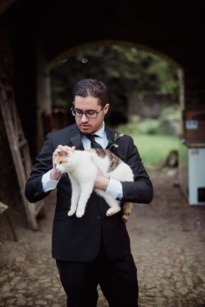 destination wedding in a barn Aislinn Events groom with cat