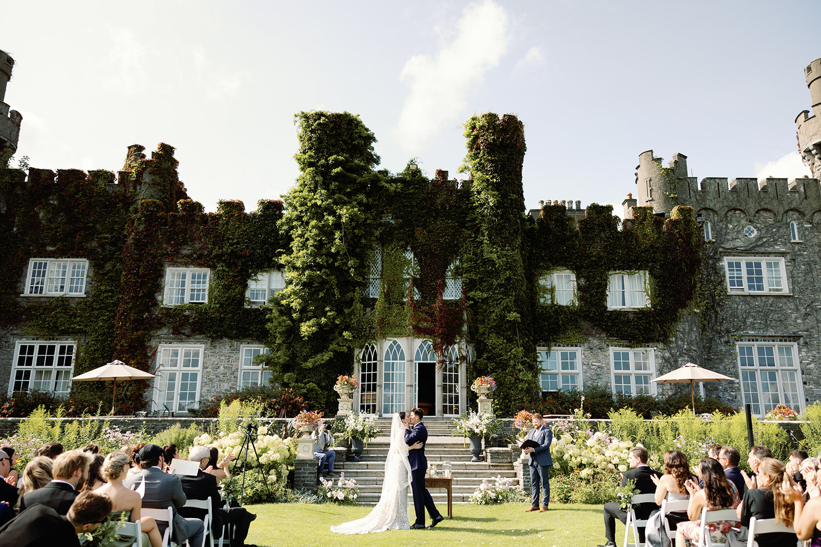 outside wedding in front of castle with ivy