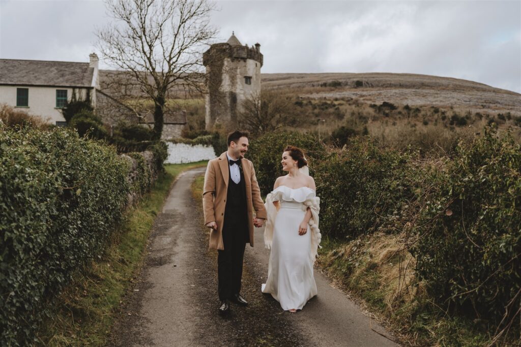 loving strolling down lane outside Newtown castle after getting married