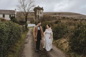 loving strolling down lane outside Newtown castle after getting married