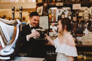 ireland wedding castle happy couple having a pint of stout