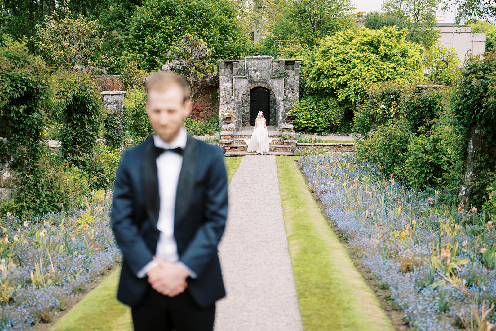 groom waiting for his bride in a first look picture 