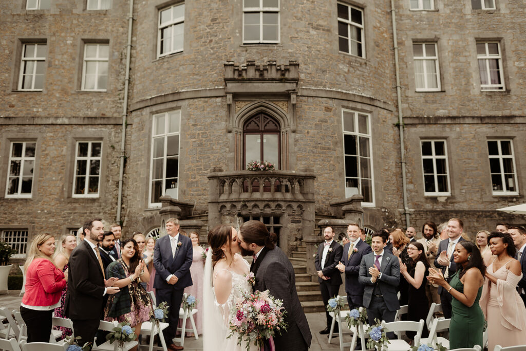 bride and groom kissing outside after the ceremony at an Aislinn Events wedding