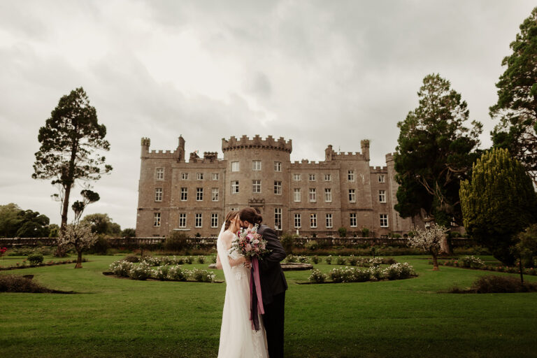 Married couple kissing outside of Markree Castle after their wedding