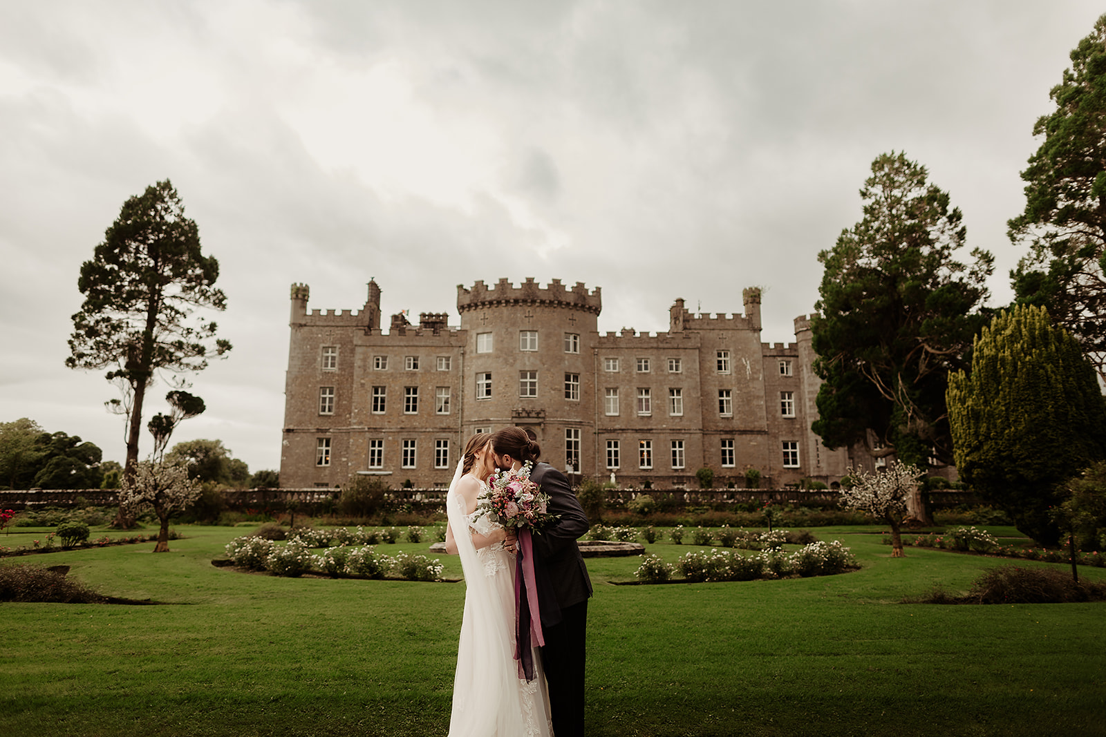 Married couple kissing outside of Markree Castle after their wedding