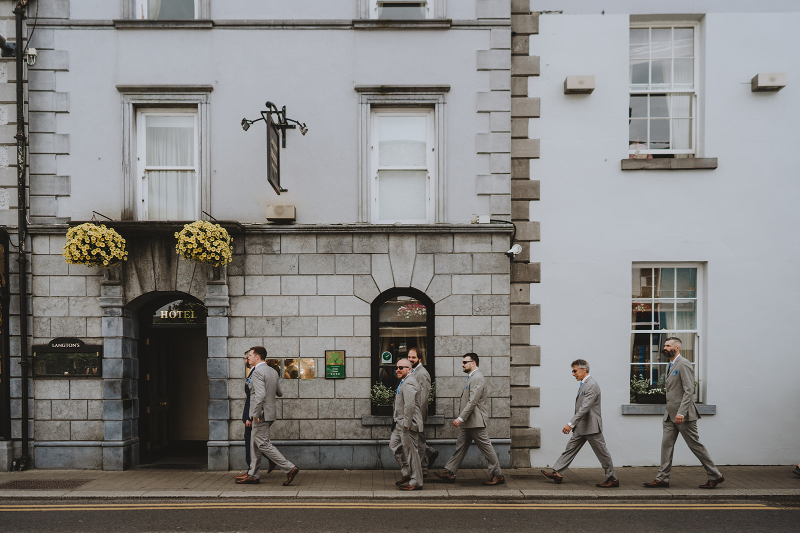 groom party walking in kilkenney all behind each other